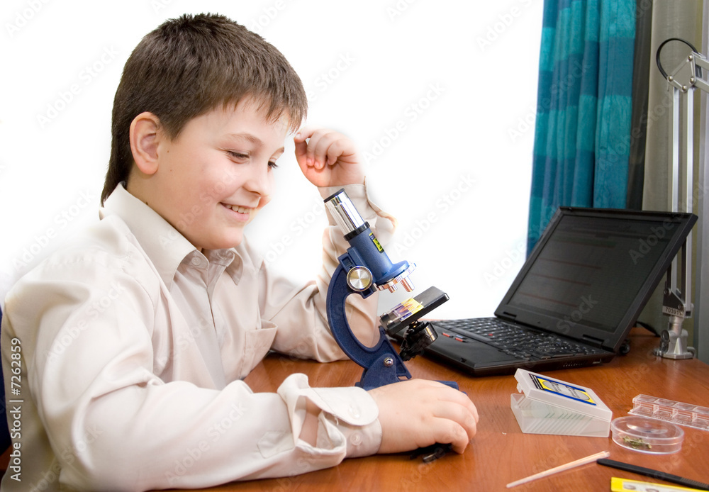 boy with a microscope in the laboratory boy with a microscope in the laboratory