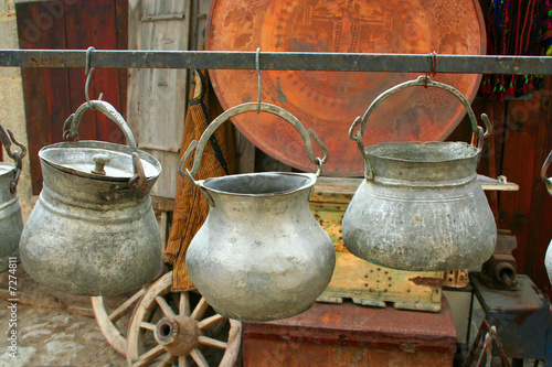 Three antique pots hanging