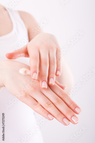 woman applying cream on her hands