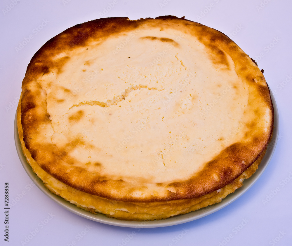 whole cheese cake on the white background whole cheese cake on the white background