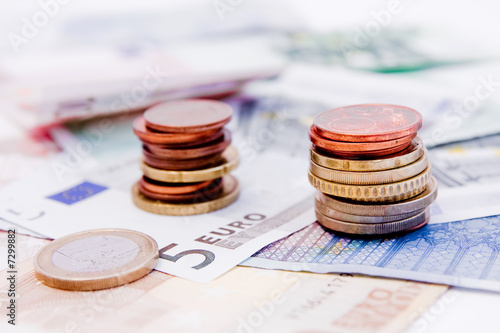 Euro banknotes with various coins photo
