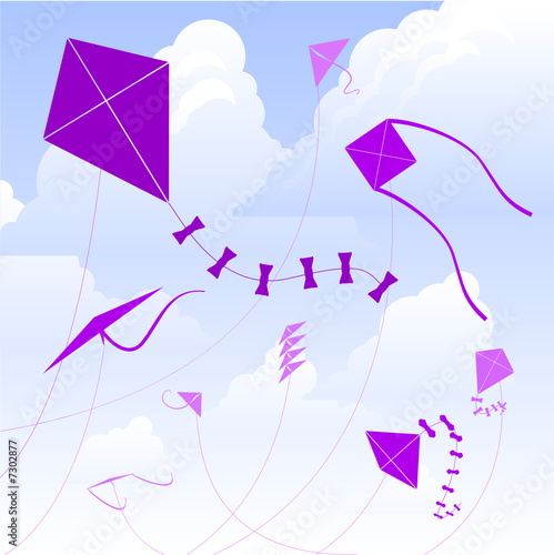 Kites flying against a cloudy sky 