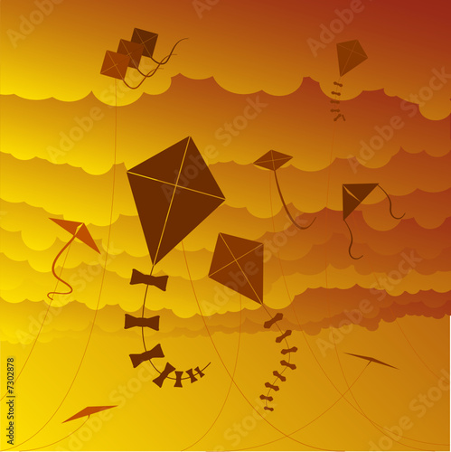 kites flying against a sunset sky 