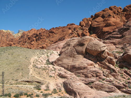 Red Rock Canyon Mountains in Las Vegas with clear blue sky.