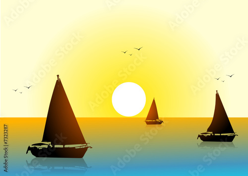 Boats in the sea at sunset