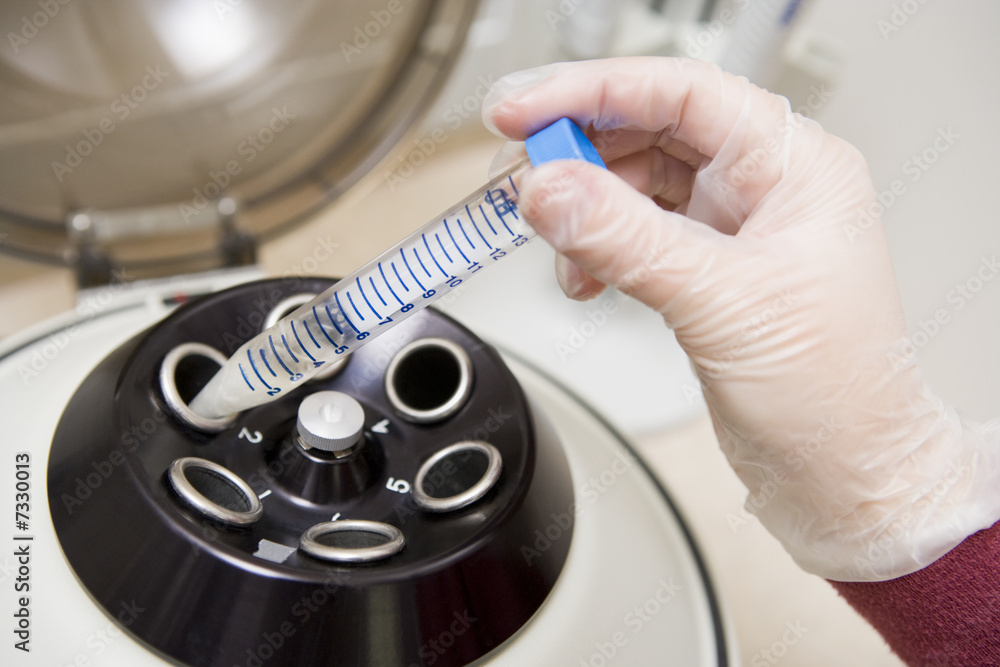 Obraz na plátně Embryologist putting sample into centrifuge