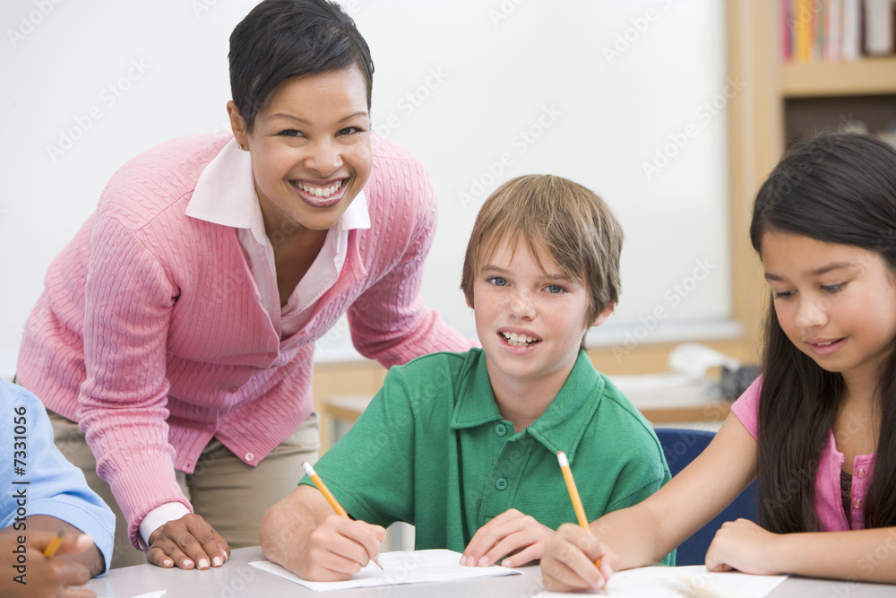 Teacher and pupil in elementary school classroom Teacher and pupil in elementary school classroom