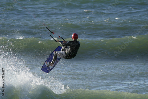 A kitesurfer riding the waves in the ocean