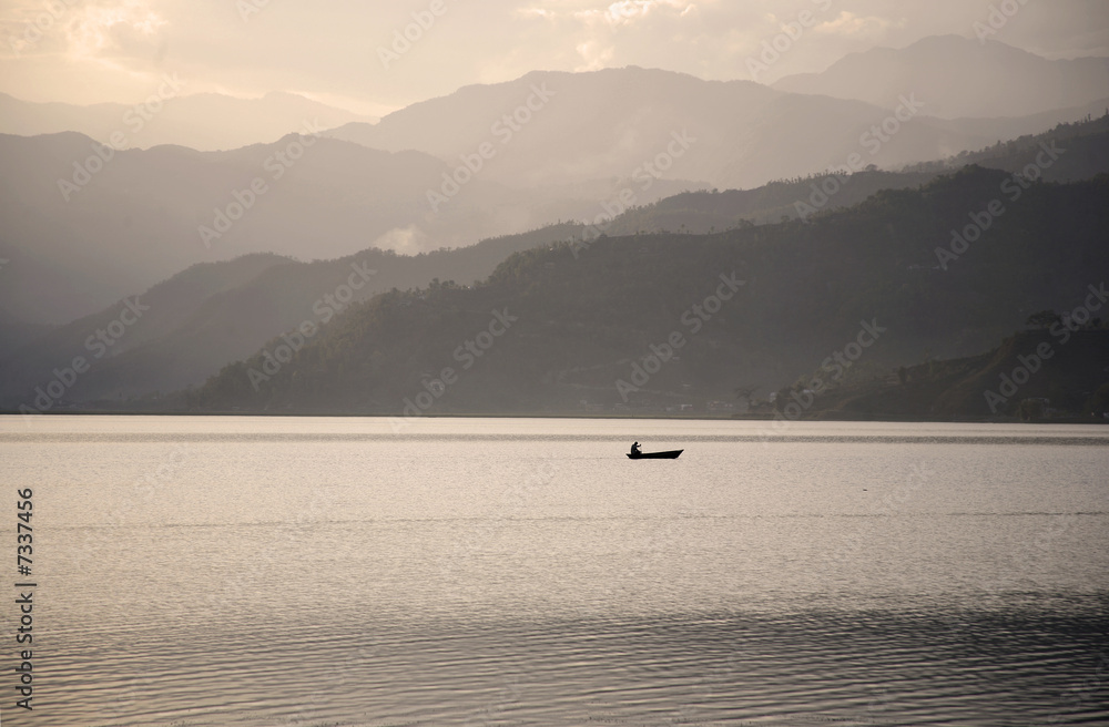 boat on fewa lake at sunset, pokhara, nepal boat on fewa lake at sunset, pokhara, nepal