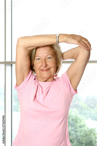 Beautiful mature woman doing her stretching exercise 
