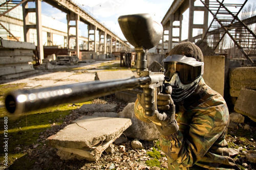 Paintball player with gun photo