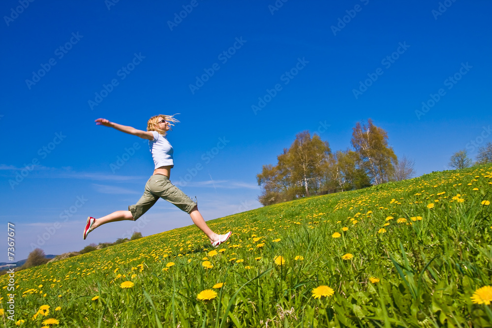 young female having fun on flowery meadow young female having fun on flowery meadow