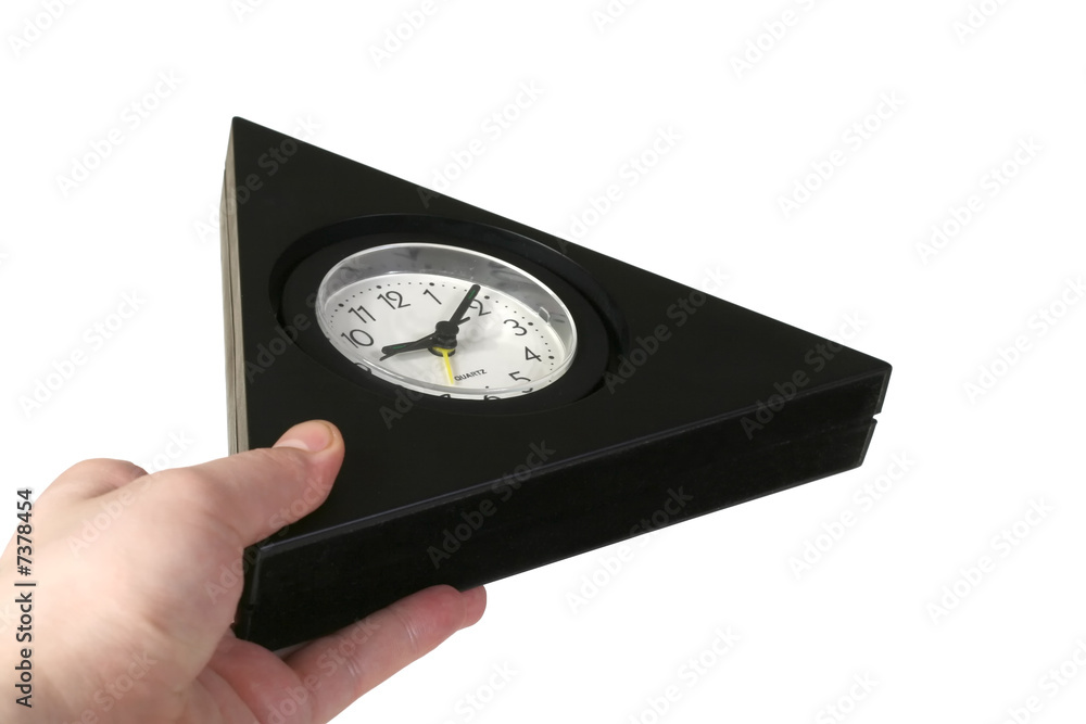 The hand hold triangular clock on a white background The hand hold triangular clock on a white background