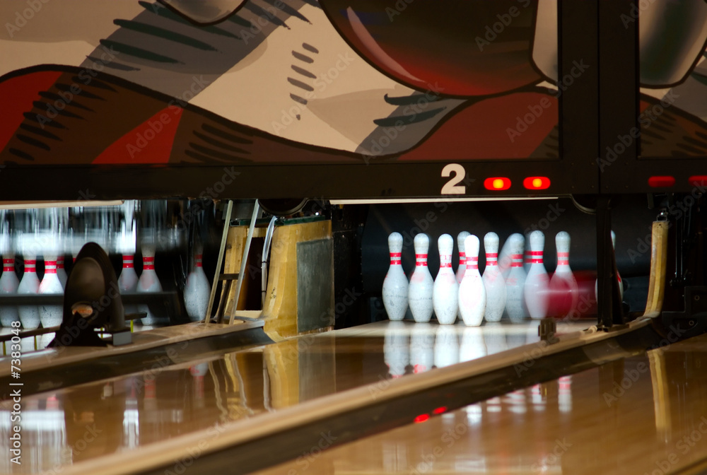 bowling pins being knocked down Stock Photo Adobe Stock