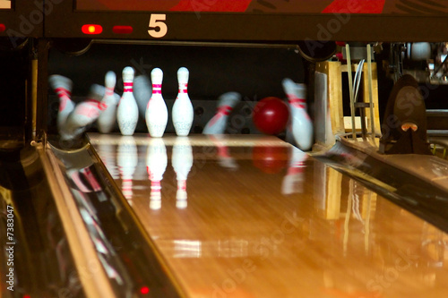 Bowling pins being knocked down. 