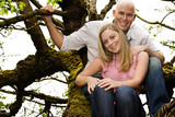 Happy, healthy young couple in a tree