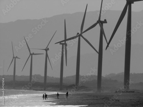 Children playing under the power windmills of Bangui bay