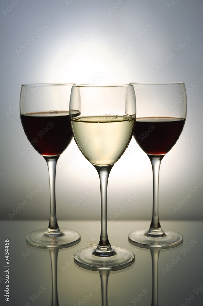 Three glasses with red and white wine