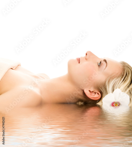 Beautiful young woman ready for spa treatment near the water