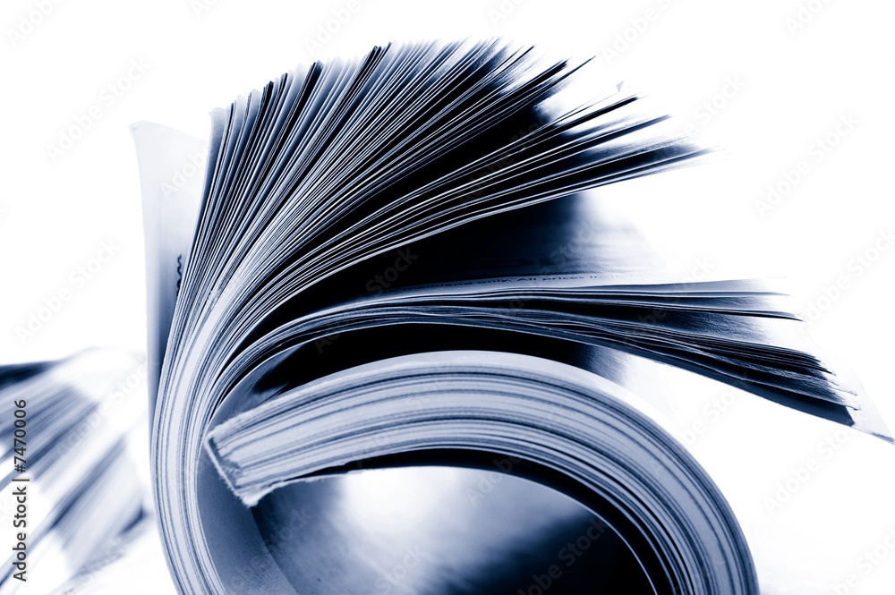 Closeup of rolled magazine pages, on white Closeup of rolled magazine pages, on white