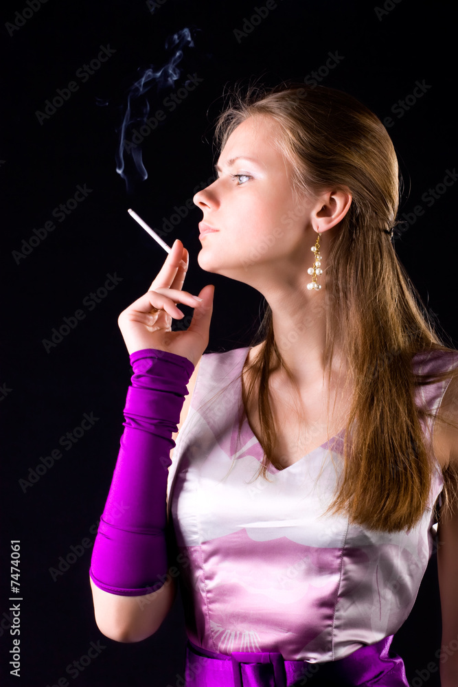 Obraz premium Young elegant woman with cigarette