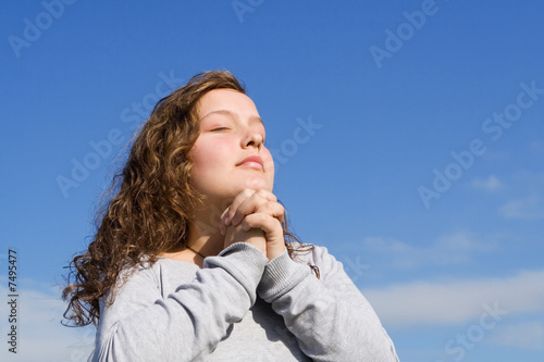 christian child praying hands clasped in prayer