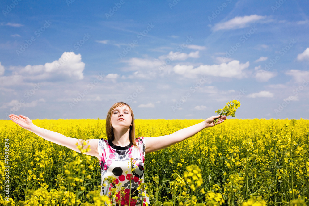 Happy girl on the rape field. Happy girl on the rape field.