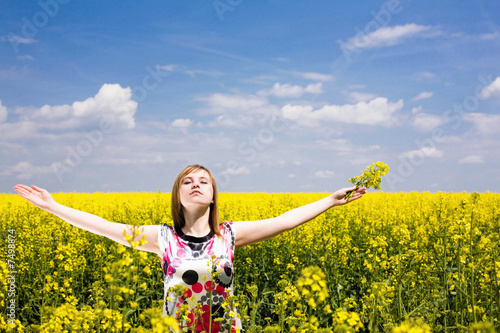 Happy girl on the rape field.