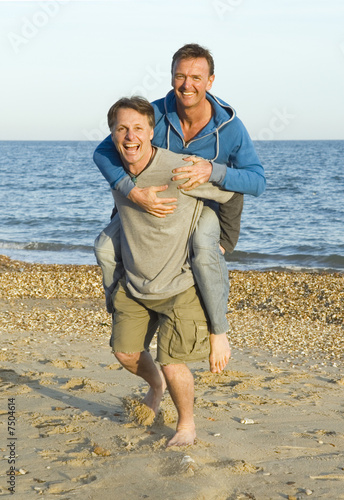 A happy smiling gay couple fooling around.