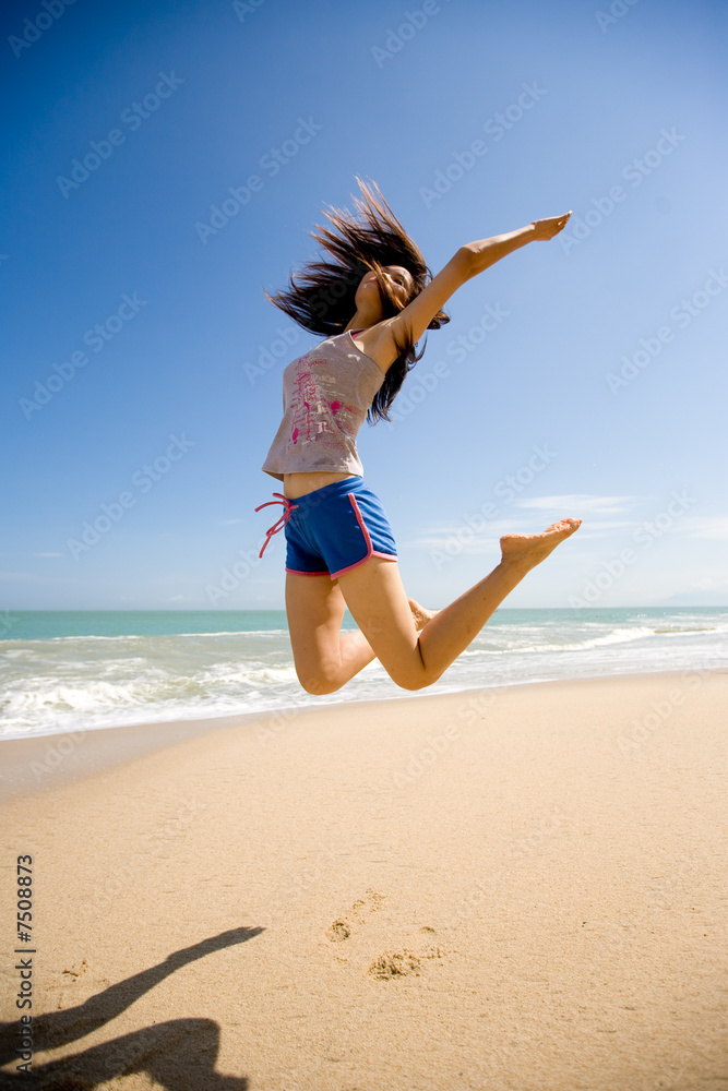 Naklejka premium young woman jumping happily