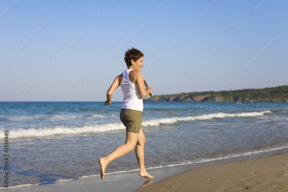 Yong girl running on the beach