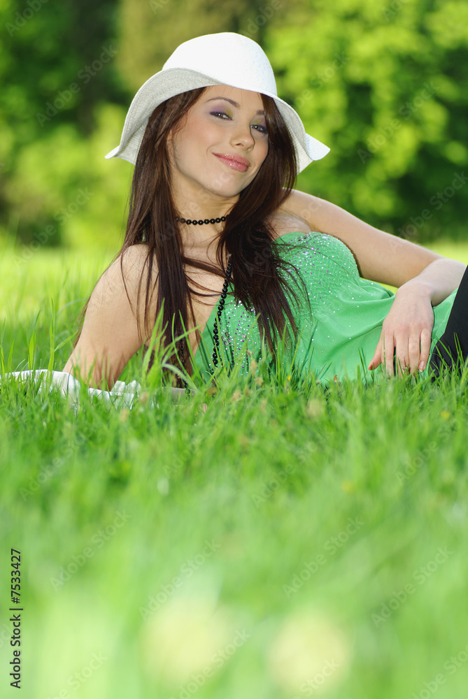 Beautiful woman sitting in the grass. Beautiful woman sitting in the grass.