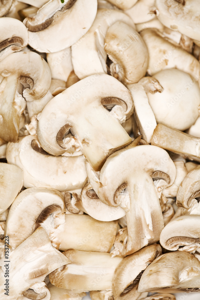 slices of cultivated mushroom shot from above slices of cultivated mushroom shot from above