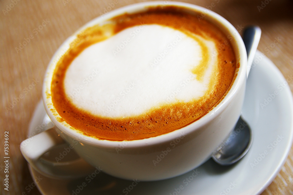 Closeup of a cup of frothy cappuccino coffee Closeup of a cup of frothy cappuccino coffee