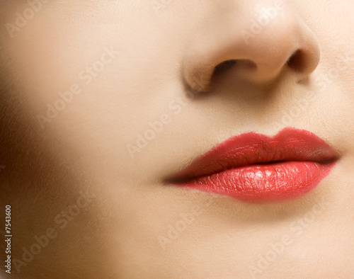Beautiful woman's face with red lips
