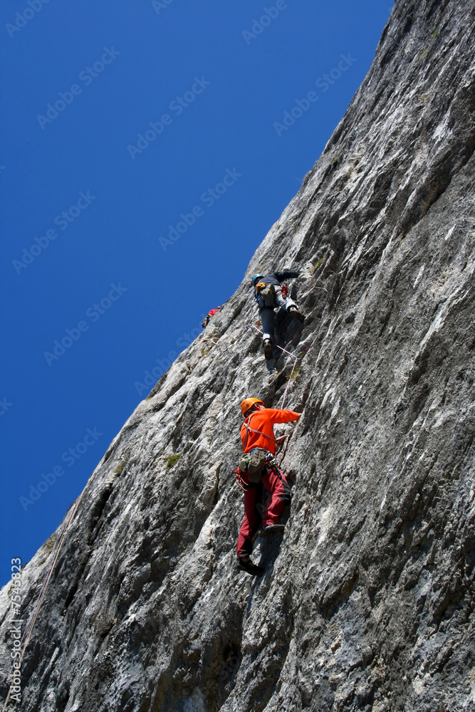 Climber team climbing on rock 1