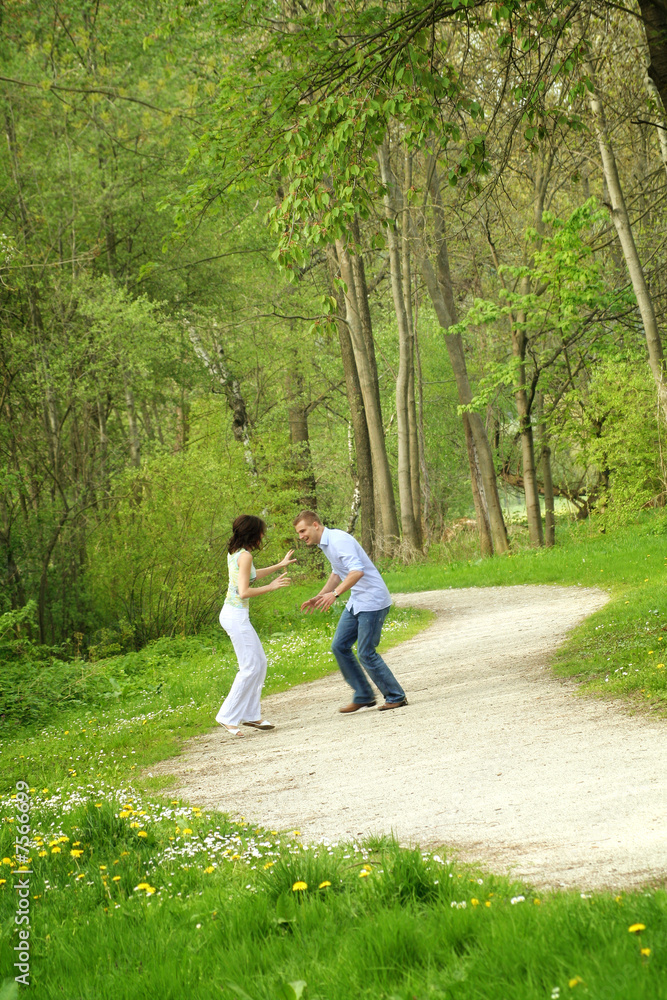 Fototapeta premium young couple is running on a way