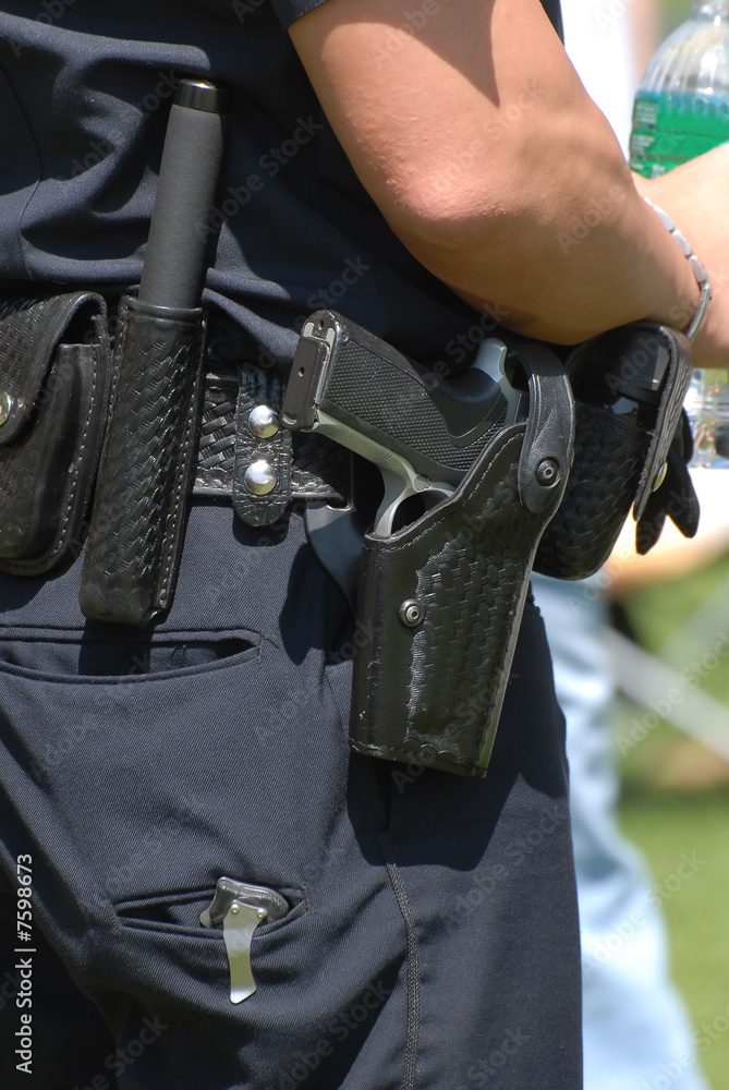 Police officer and gun holster Photos | Adobe Stock