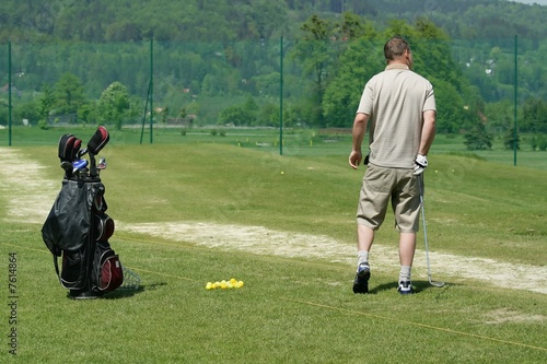 golfer on training and golf bag