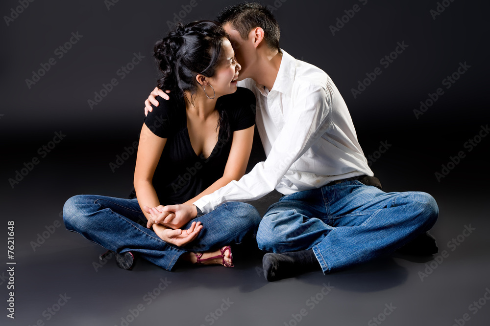 happy young couple with a kiss on the cheek happy young couple with a kiss on the cheek