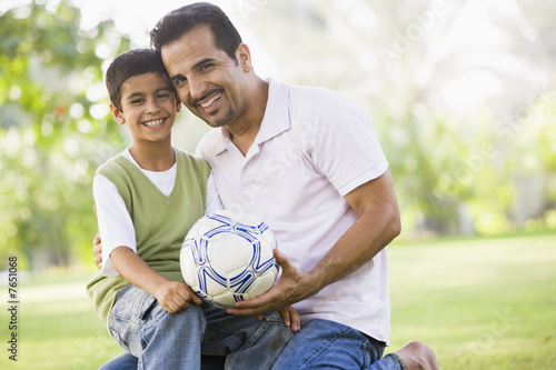 Father and son playing football