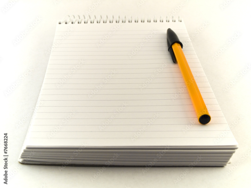 Ballpoint Pen and Notepad on White Background