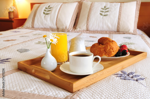 Breakfast on a bed in a hotel room Fototapeta