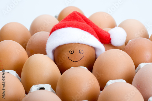 Brown eggs and a santa hat, isolated