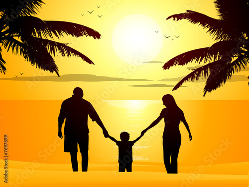 Family on a tropical beach at sunset