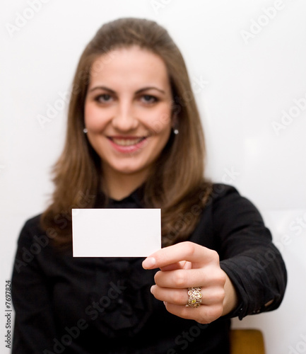 Portrait of a beautiful businesswoman holding a blank card