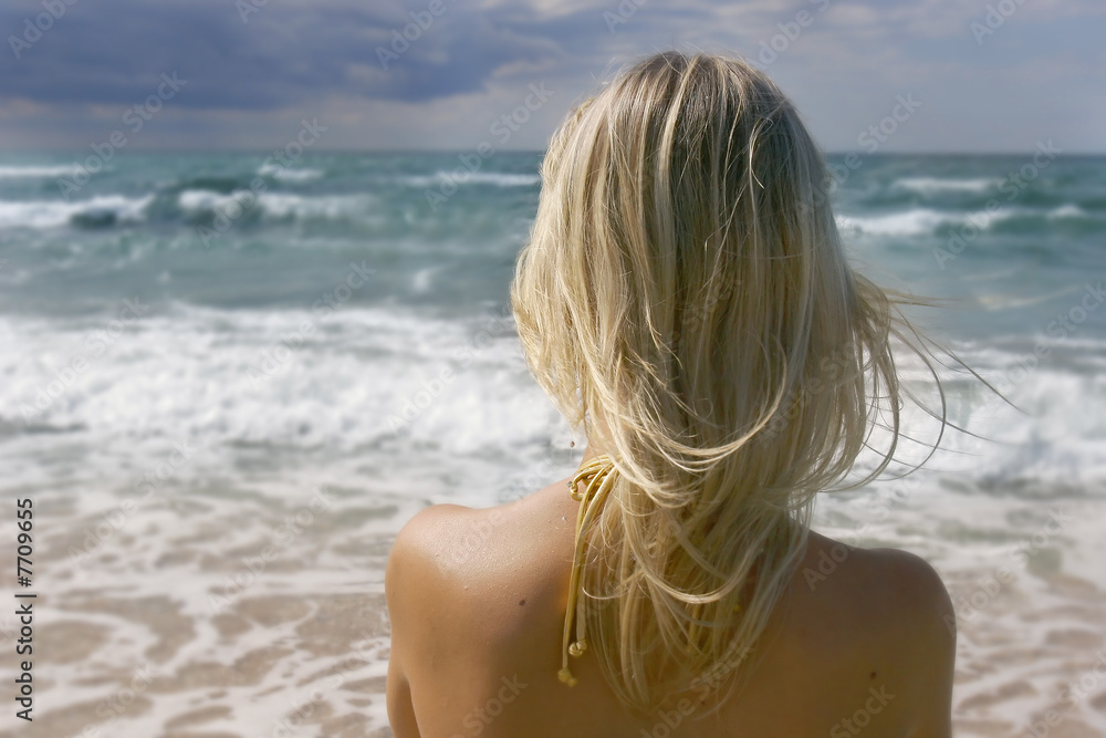 girl looking into stormy sea