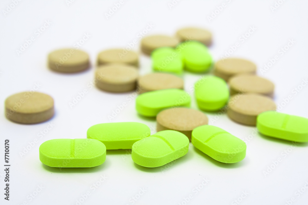 multi coloured pills on white background