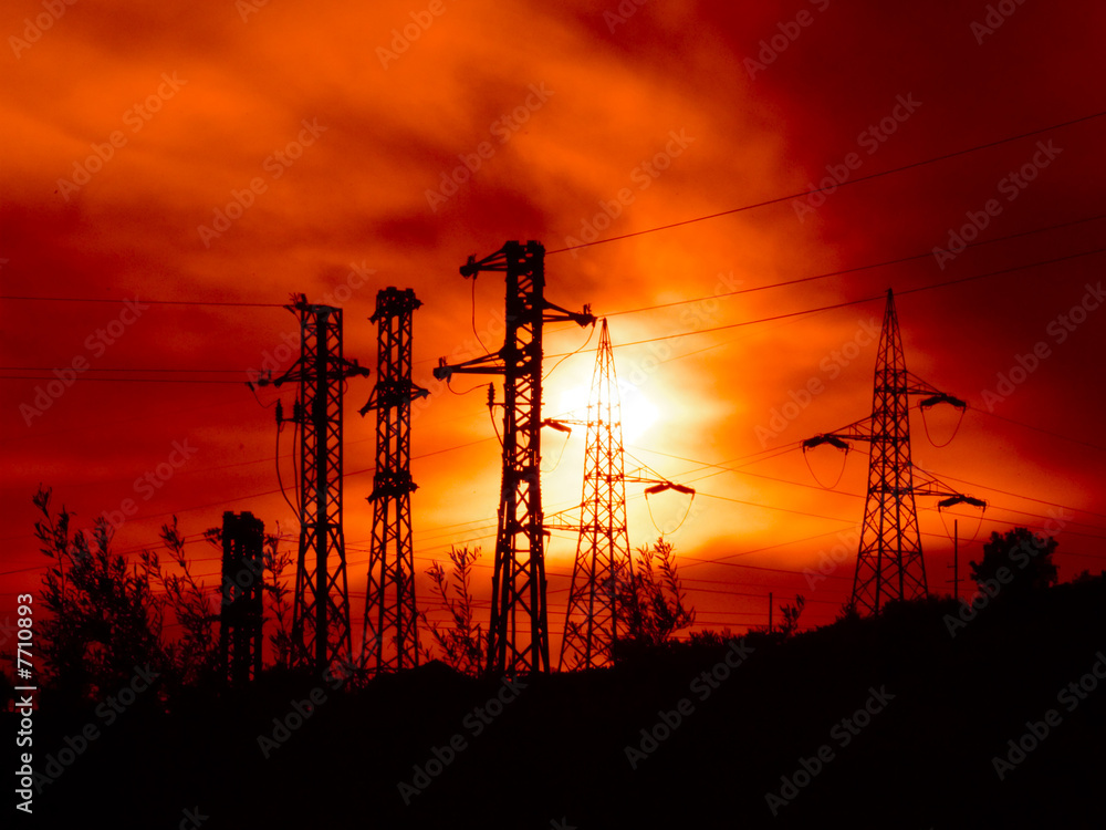 Naklejka premium electricity pylons at the sunset