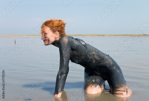 Girl taking mud bath outdoor